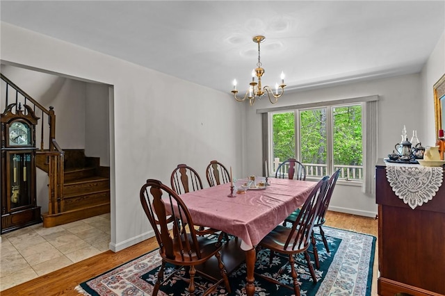 84 River Farms Dr Unit 84, West Warwick, RI 02893 - dining area with a chandelier, stairway, light wood-type flooring, and baseboards