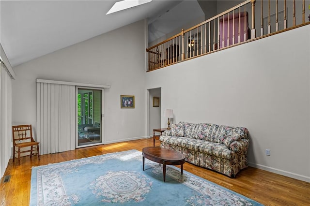 84 River Farms Dr Unit 84, West Warwick, RI 02893 - living room featuring high vaulted ceiling, a skylight, wood finished floors, and baseboards