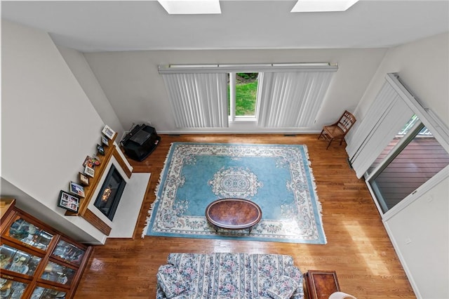 84 River Farms Dr Unit 84, West Warwick, RI 02893 - living area featuring a glass covered fireplace, wood finished floors, and a skylight