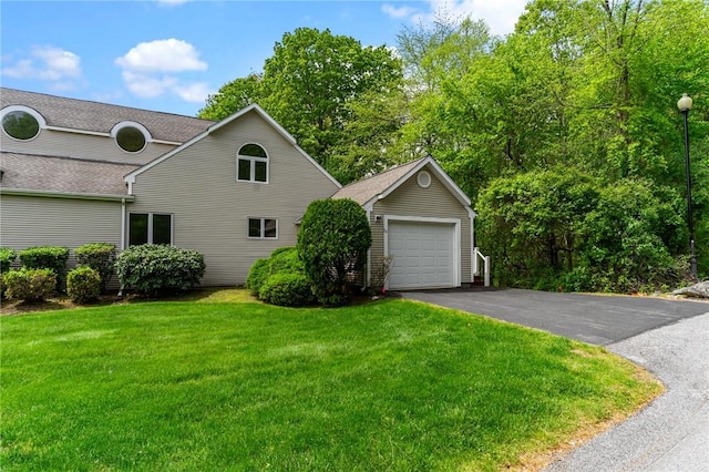 84 River Farms Dr Unit 84, West Warwick, RI 02893 - view of side of home featuring a yard, an outdoor structure, driveway, a shingled roof, and a detached garage