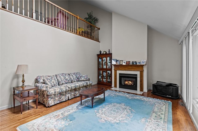 84 River Farms Dr Unit 84, West Warwick, RI 02893 - living area featuring high vaulted ceiling, wood finished floors, a fireplace with flush hearth, and baseboards