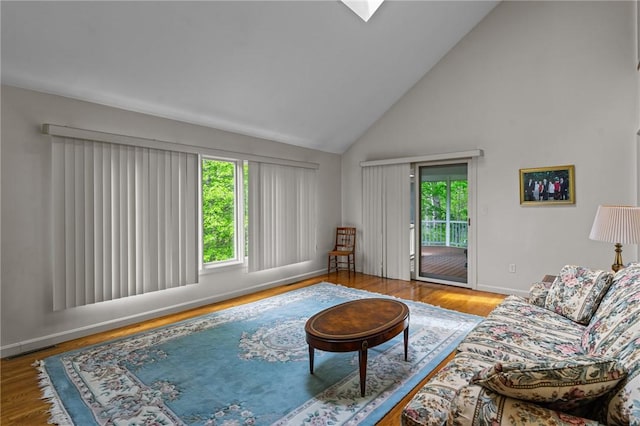 84 River Farms Dr Unit 84, West Warwick, RI 02893 - living area featuring healthy amount of natural light, high vaulted ceiling, wood finished floors, and baseboards