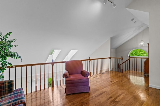 84 River Farms Dr Unit 84, West Warwick, RI 02893 - sitting room with lofted ceiling, wood finished floors, a skylight, and an upstairs landing