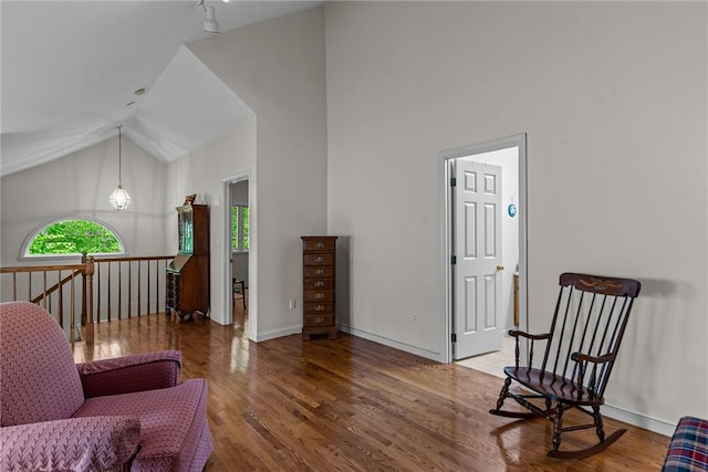 84 River Farms Dr Unit 84, West Warwick, RI 02893 - sitting room with wood finished floors, baseboards, high vaulted ceiling, and an upstairs landing