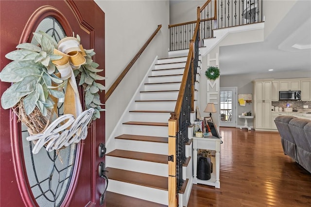 132 Theresa Marie Ave, Woonsocket, RI 02895 - stairway featuring a towering ceiling, wood finished floors, and baseboards