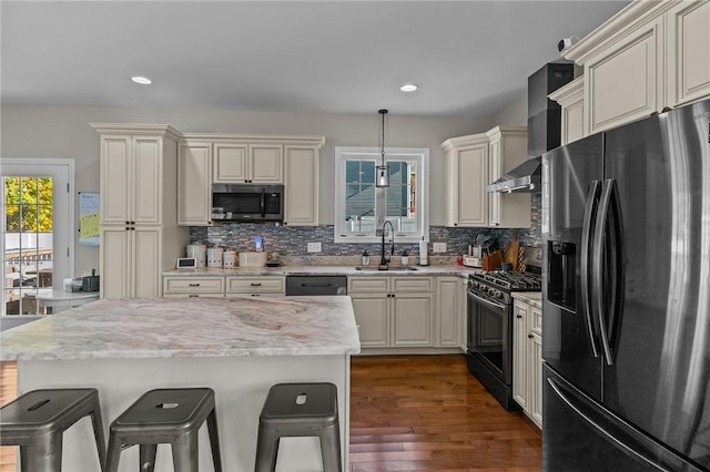 132 Theresa Marie Ave, Woonsocket, RI 02895 - kitchen featuring fridge with ice dispenser, black gas range oven, stainless steel microwave, a sink, and a kitchen bar