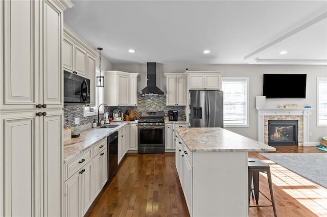 132 Theresa Marie Ave, Woonsocket, RI 02895 - kitchen with stainless steel appliances, wall chimney exhaust hood, open floor plan, a sink, and tasteful backsplash