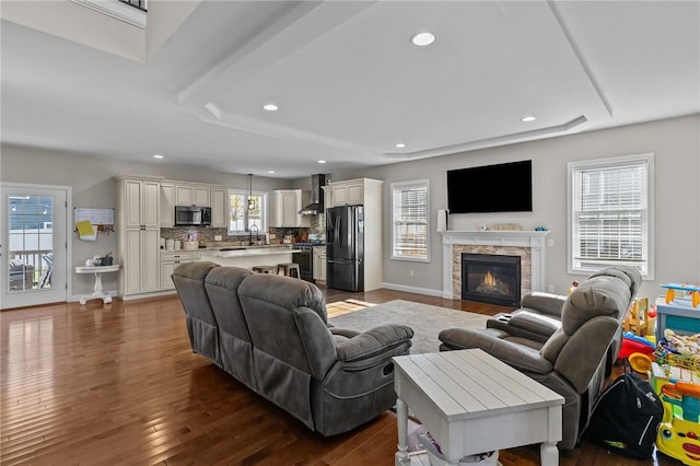 132 Theresa Marie Ave, Woonsocket, RI 02895 - living room with recessed lighting, dark wood-type flooring, a glass covered fireplace, and baseboards