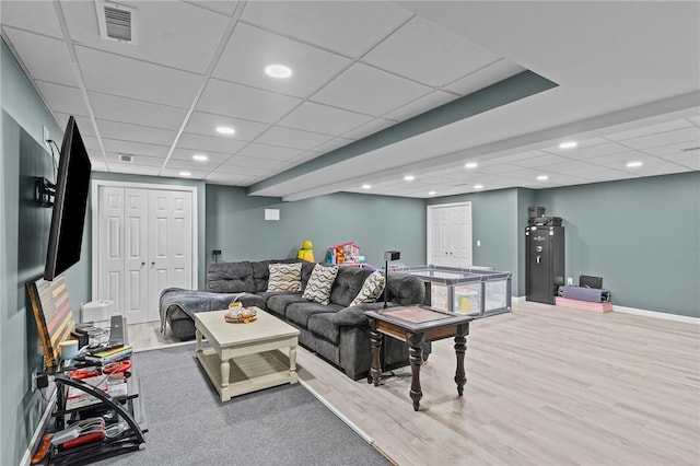 132 Theresa Marie Ave, Woonsocket, RI 02895 - living area with a paneled ceiling, recessed lighting, wood finished floors, baseboards, and water heater