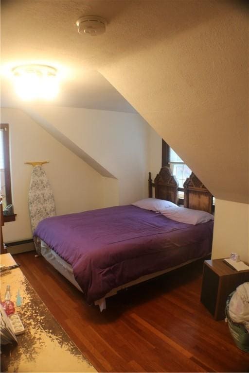 281 Auburn St, Cranston, RI 02910 - bedroom with wood finished floors, vaulted ceiling, and a baseboard heating unit