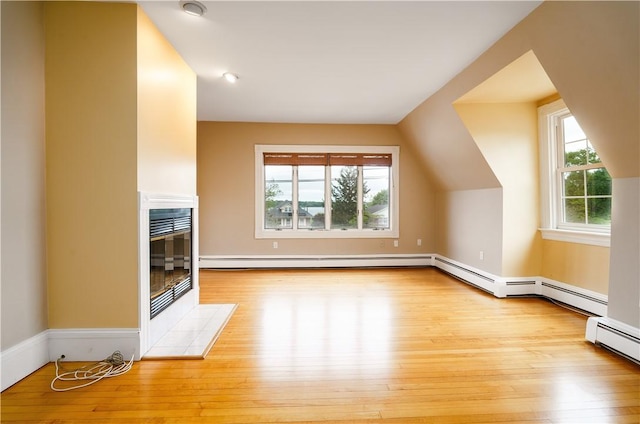 1291 Narragansett Blvd Unit 6, Cranston, RI 02905 - bonus room featuring hardwood / wood-style floors, a baseboard radiator, a tiled fireplace, and baseboards