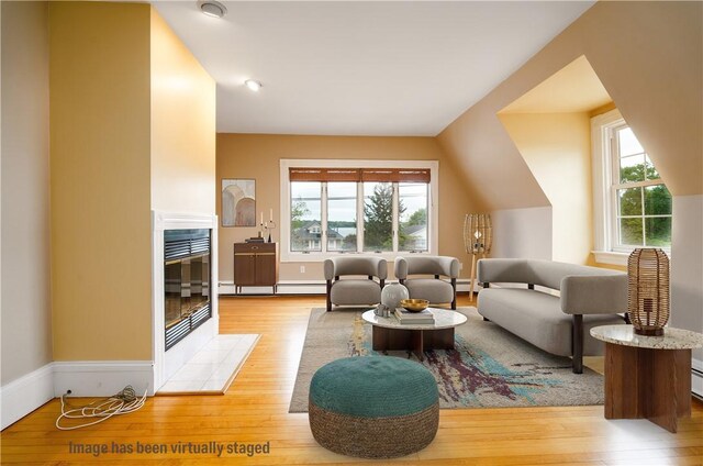 1291 Narragansett Blvd Unit 6, Cranston, RI 02905 - living room featuring light wood-style floors, a baseboard radiator, and a tiled fireplace