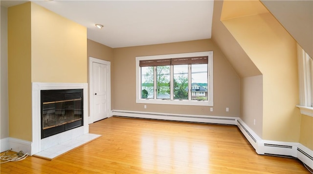 1291 Narragansett Blvd Unit 6, Cranston, RI 02905 - unfurnished living room featuring a tile fireplace, wood finished floors, and a baseboard heating unit