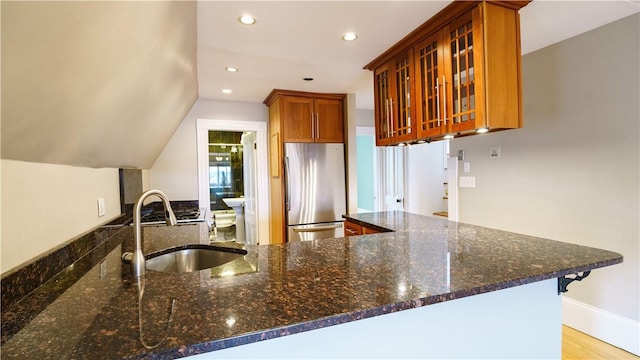 1291 Narragansett Blvd Unit 6, Cranston, RI 02905 - kitchen with freestanding refrigerator, a sink, dark stone counters, recessed lighting, and brown cabinetry
