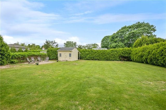 86 Weekapaug Rd, Westerly, RI 02891 - view of grassy yard featuring an outdoor fire pit, a patio area, and an outbuilding