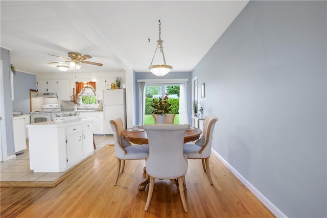 86 Weekapaug Rd, Westerly, RI 02891 - dining room with light wood-type flooring, a ceiling fan, and baseboards