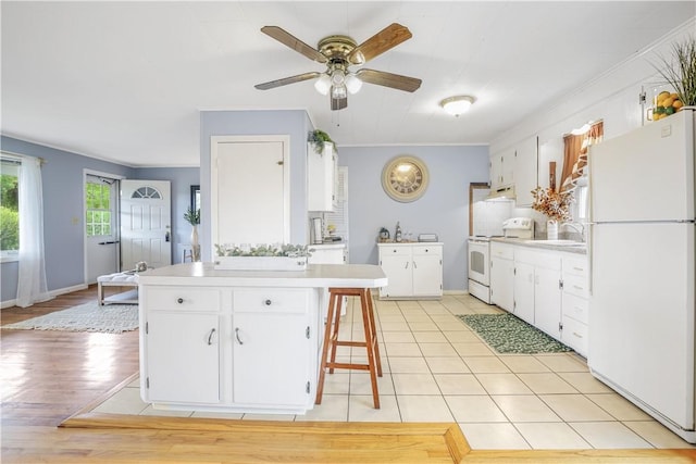 86 Weekapaug Rd, Westerly, RI 02891 - kitchen with white appliances, light countertops, under cabinet range hood, ceiling fan, and white cabinetry