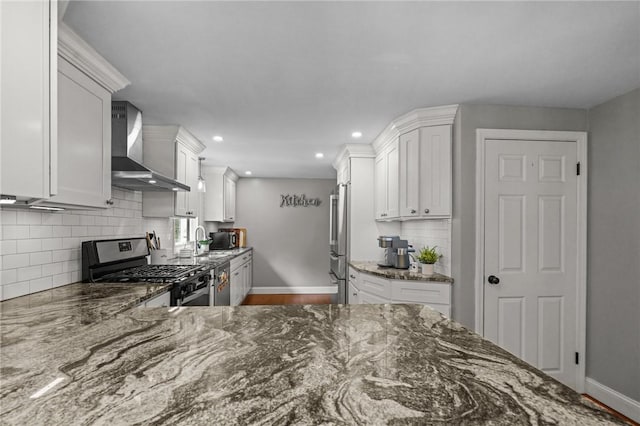 10 Bigelow Rd, Johnston, RI 02919 - kitchen with wall chimney exhaust hood, appliances with stainless steel finishes, baseboards, a sink, and dark stone counters