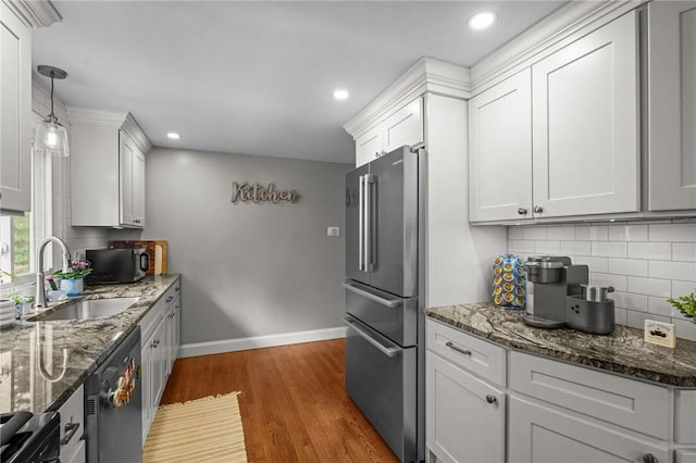 10 Bigelow Rd, Johnston, RI 02919 - kitchen with stainless steel appliances, a sink, wood finished floors, tasteful backsplash, and dark stone countertops