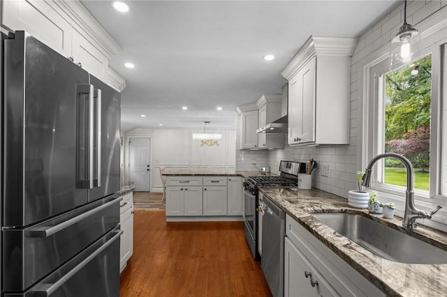 10 Bigelow Rd, Johnston, RI 02919 - kitchen with stainless steel appliances, a sink, a peninsula, white cabinetry, and recessed lighting