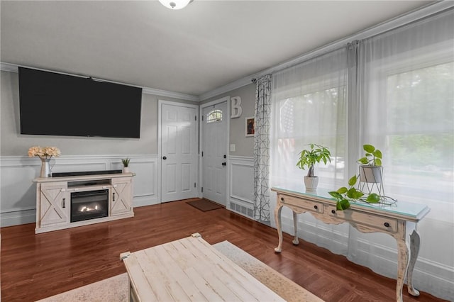 10 Bigelow Rd, Johnston, RI 02919 - living area featuring crown molding, a decorative wall, wood finished floors, a fireplace, and a wainscoted wall