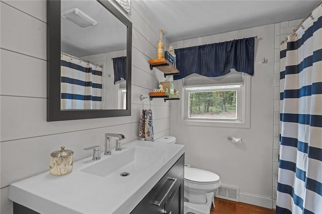 10 Bigelow Rd, Johnston, RI 02919 - bathroom with toilet, vanity, wood finished floors, curtained shower, and baseboards