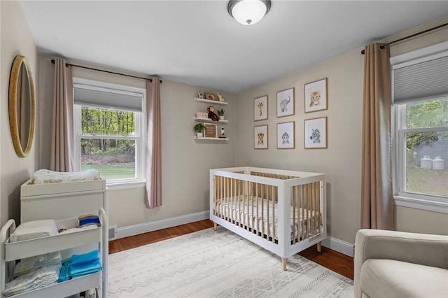 10 Bigelow Rd, Johnston, RI 02919 - bedroom with wood finished floors, multiple windows, and baseboards