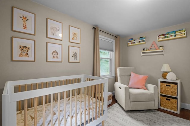 10 Bigelow Rd, Johnston, RI 02919 - bedroom with a nursery area, wood finished floors, and baseboards