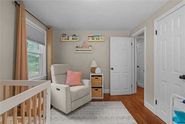 10 Bigelow Rd, Johnston, RI 02919 - bedroom featuring wood finished floors, a crib, and baseboards