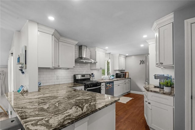 10 Bigelow Rd, Johnston, RI 02919 - kitchen featuring wall chimney exhaust hood, appliances with stainless steel finishes, a peninsula, tasteful backsplash, and dark wood-type flooring
