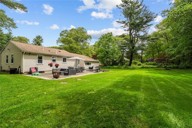 10 Bigelow Rd, Johnston, RI 02919 - back of property featuring a patio area, a lawn, and central air condition unit