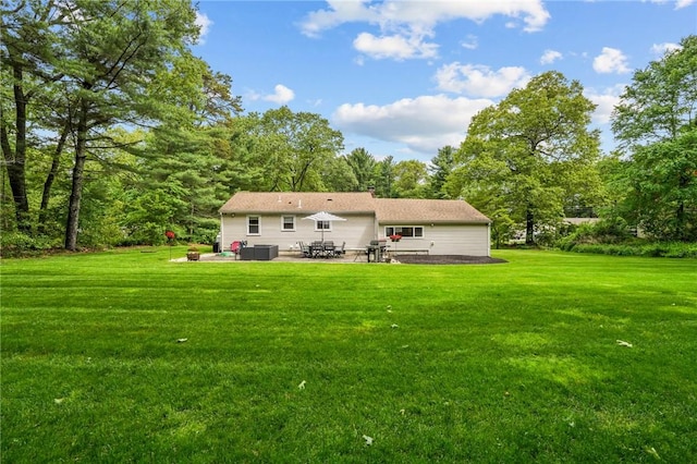 10 Bigelow Rd, Johnston, RI 02919 - rear view of house with a patio area and a lawn
