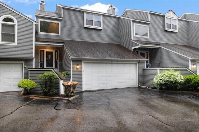 5390 Post Rd Unit 9, Warwick, RI 02818 - view of property featuring a chimney, an attached garage, and asphalt driveway
