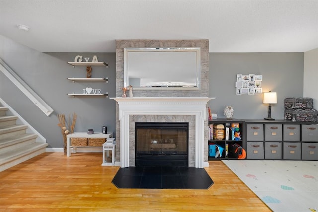 5390 Post Rd Unit 9, Warwick, RI 02818 - living area with wood finished floors, a high end fireplace, and stairway