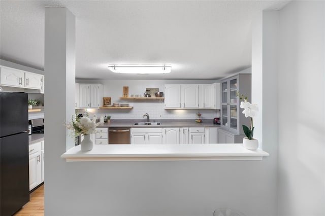5390 Post Rd Unit 9, Warwick, RI 02818 - kitchen with freestanding refrigerator, stainless steel dishwasher, a sink, white cabinetry, and open shelves