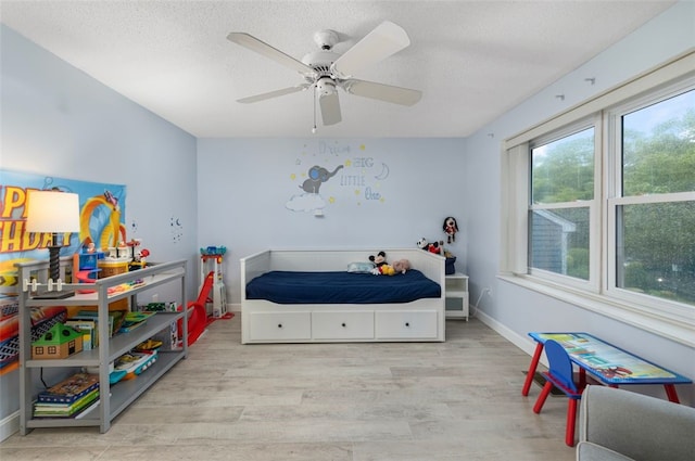 5390 Post Rd Unit 9, Warwick, RI 02818 - bedroom with wood finished floors, a textured ceiling, ceiling fan, and baseboards