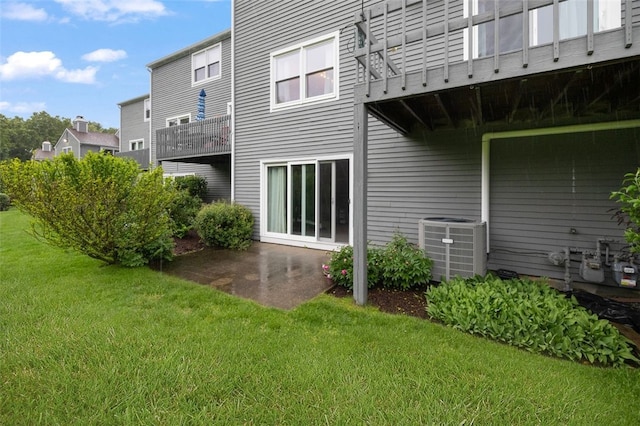 5390 Post Rd Unit 9, Warwick, RI 02818 - back of house with central air condition unit, a yard, a balcony, and a patio