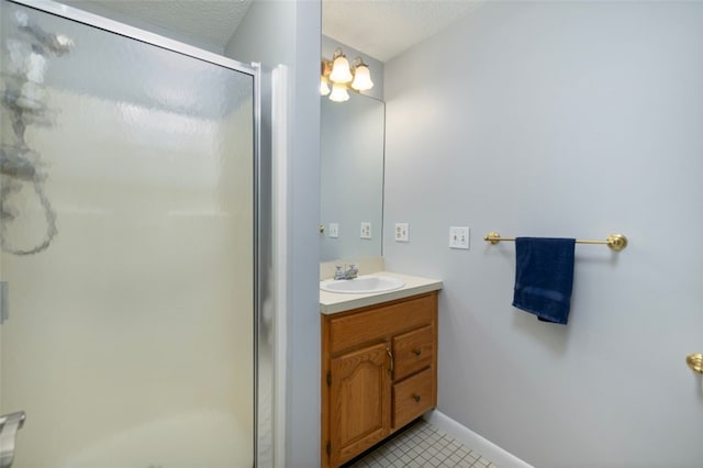 5390 Post Rd Unit 9, Warwick, RI 02818 - bathroom featuring a stall shower, vanity, tile patterned flooring, baseboards, and a textured ceiling