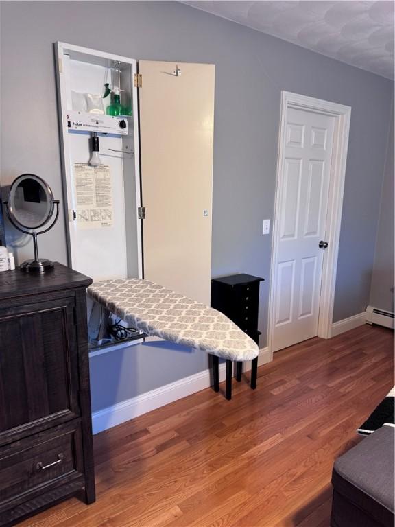 60 Farm Dr, Cumberland, RI 02864 - bedroom featuring light wood finished floors, baseboards, and a baseboard radiator