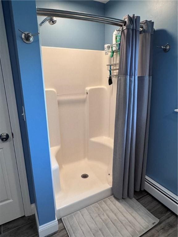 60 Farm Dr, Cumberland, RI 02864 - bathroom featuring a stall shower, wood finished floors, a baseboard heating unit, and baseboards