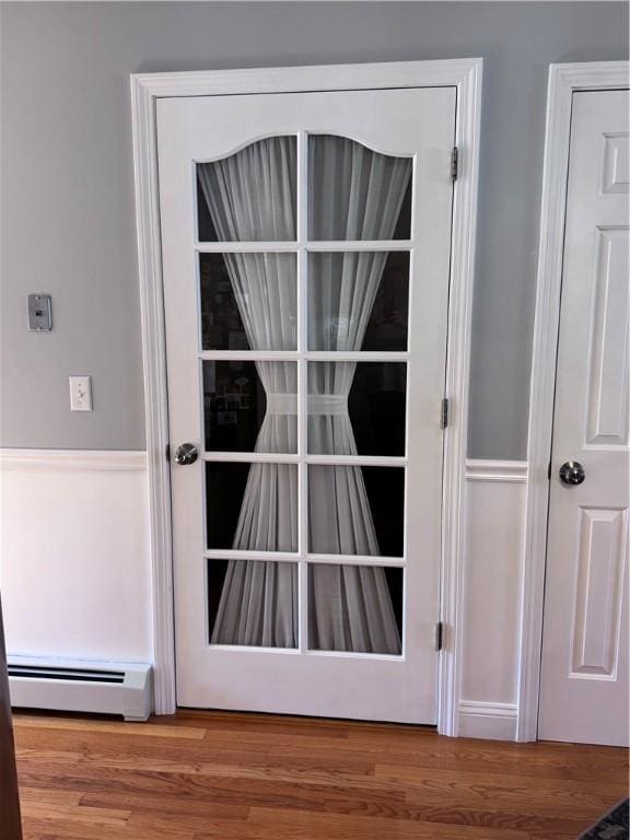 60 Farm Dr, Cumberland, RI 02864 - detailed view of a baseboard radiator and wood finished floors