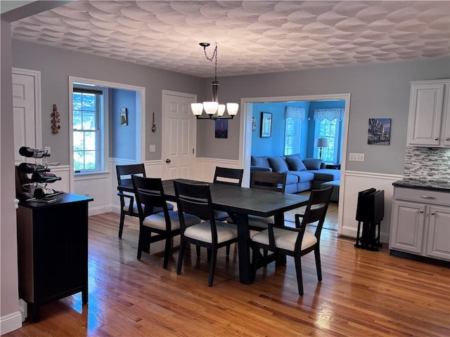 60 Farm Dr, Cumberland, RI 02864 - dining room featuring a chandelier, light wood-style flooring, and a wainscoted wall