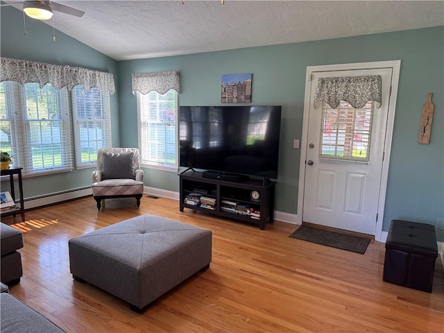 60 Farm Dr, Cumberland, RI 02864 - living area featuring a baseboard radiator, light wood-style flooring, healthy amount of natural light, a textured ceiling, and ceiling fan