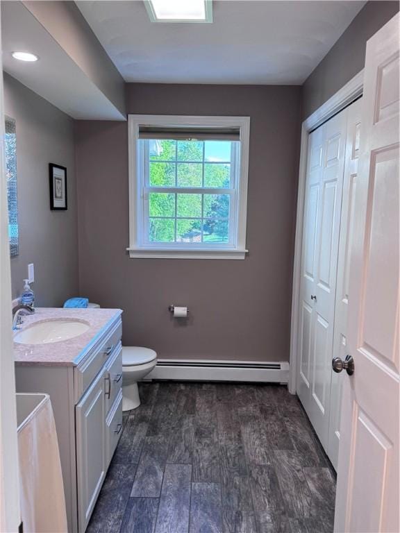 60 Farm Dr, Cumberland, RI 02864 - bathroom featuring baseboard heating, vanity, toilet, and wood finished floors