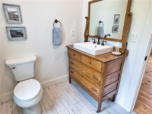 1 Hinter Way, Little Compton, RI 02837 - half bath with baseboards, wood finished floors, vanity, and toilet