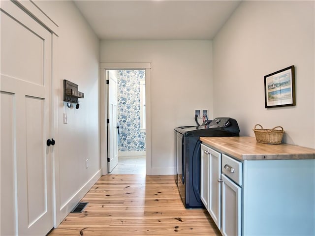 1 Hinter Way, Little Compton, RI 02837 - washroom with light wood-style floors, washing machine and dryer, baseboards, and cabinet space
