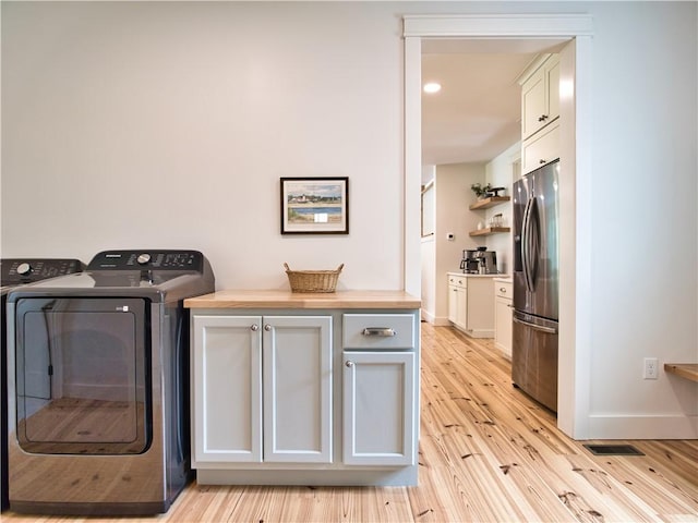 1 Hinter Way, Little Compton, RI 02837 - laundry room with light wood-style flooring, separate washer and dryer, baseboards, and cabinet space