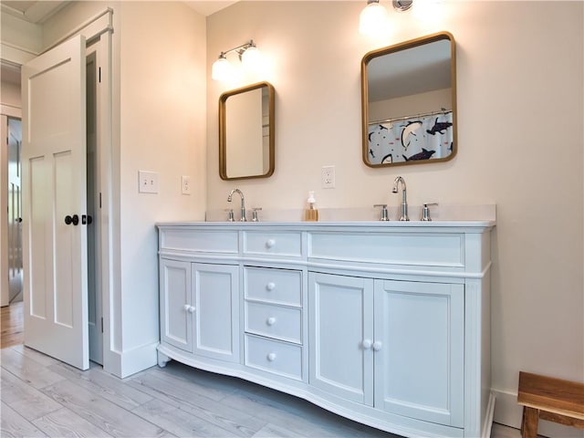 1 Hinter Way, Little Compton, RI 02837 - bathroom featuring double vanity, wood finished floors, and baseboards