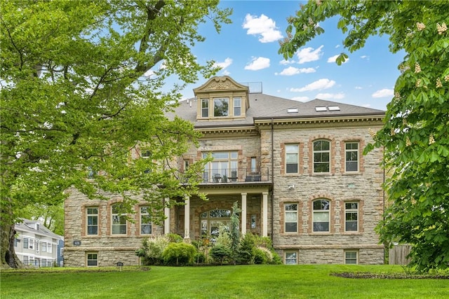 426 Spring St Unit B101, Newport, RI 02840 - rear view of house featuring a balcony, a lawn, and stone siding