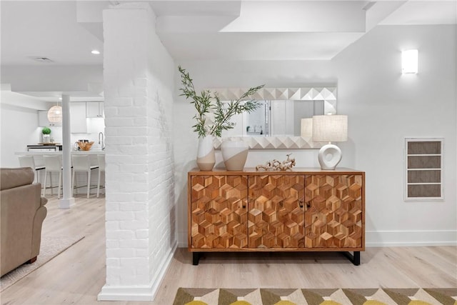 426 Spring St Unit B101, Newport, RI 02840 - bathroom featuring wood finished floors, baseboards, and a sink